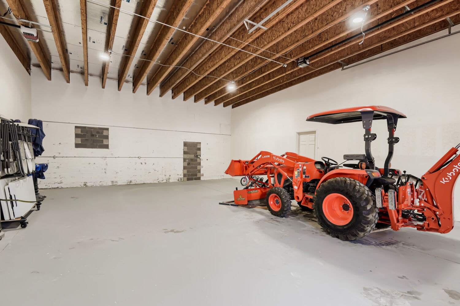 Red Kubota tractor in modern warehouse