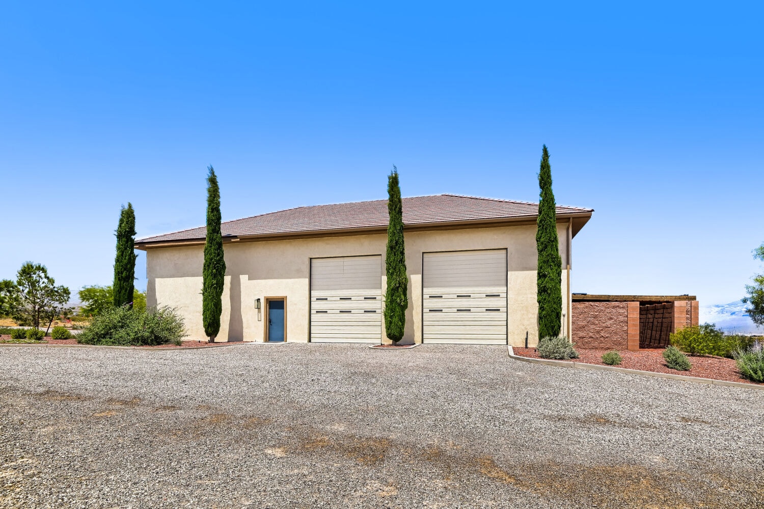 Modern garage with cypress trees landscaping