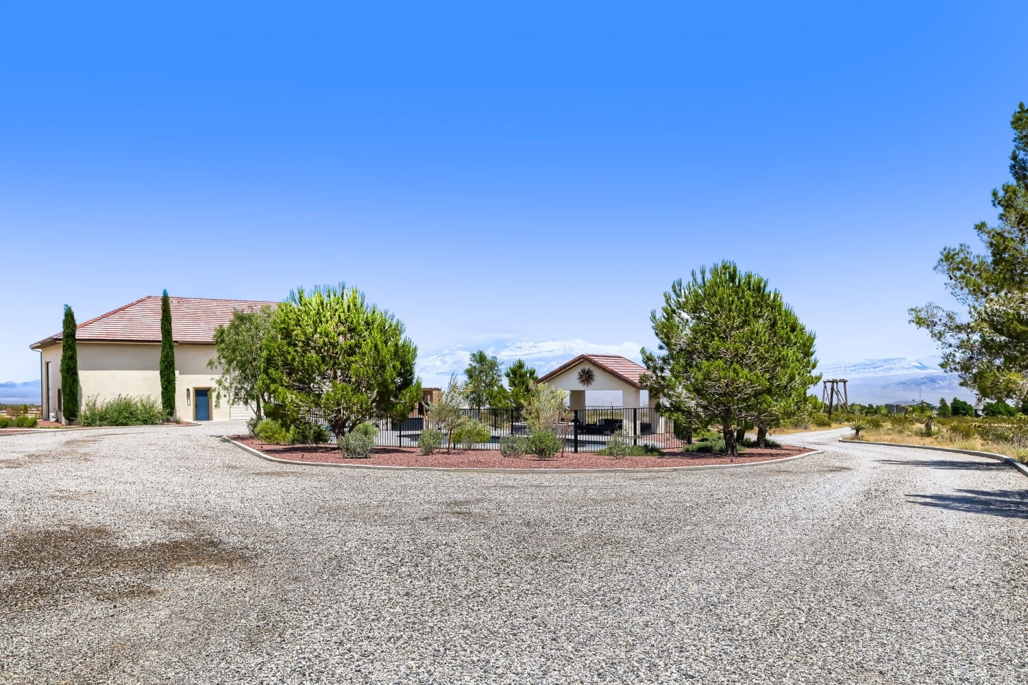 Exterior garage and workshop building with cypress trees