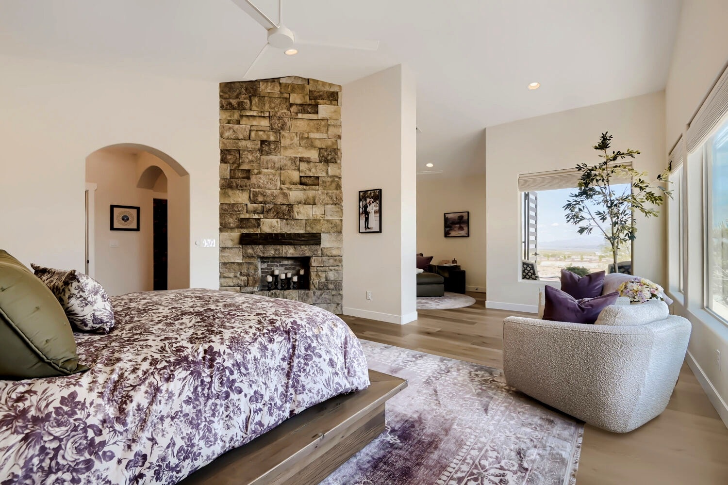 Primary bedroom with stone fireplace